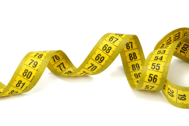 istock Yellow measuring tape isolated on white background 959806722