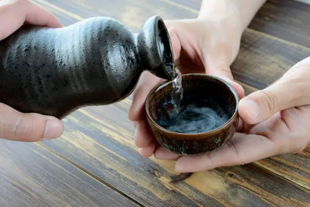 Drinking SAKE, Japanese traditional alcoholic drink