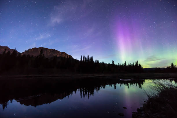 istock Aurora borealis (Northern lights) reflect in mountain lake 959808302