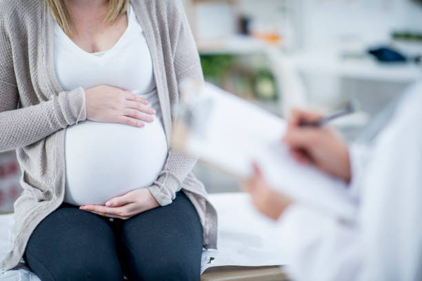 istock Pregnant Woman Holding Stomach 959811532
