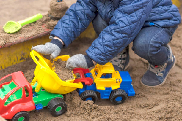 istock Children's sandbox, kids play sand building locks close-up 959815330