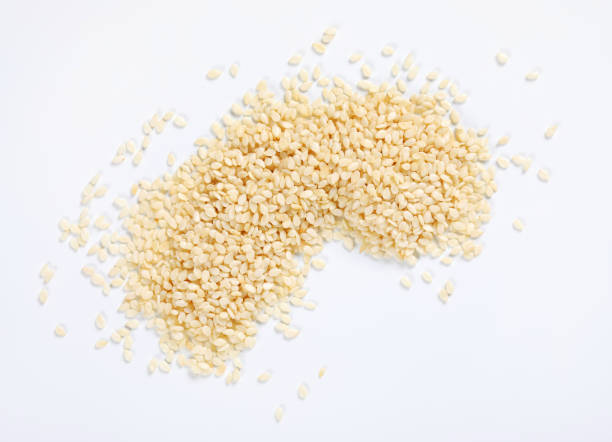 healthy sesame seeds pile of healthy sesame seeds on white background sesame seed stock pictures, royalty-free photos & images