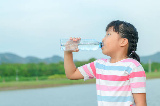 istock Child drinking pure water in nature 959822508