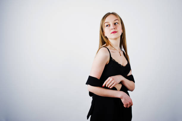 istock Girl model in black wear posed at studio on white background. 959822930