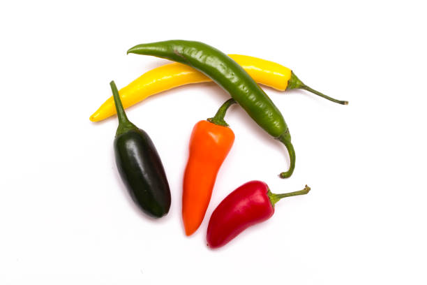 istock Five colorful chili peppers isolated on white. Top view. 959823528