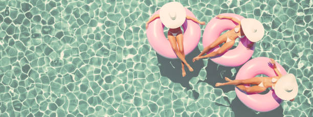 istock women swimming on float in a pool. retro style. 3d rendering 959823696