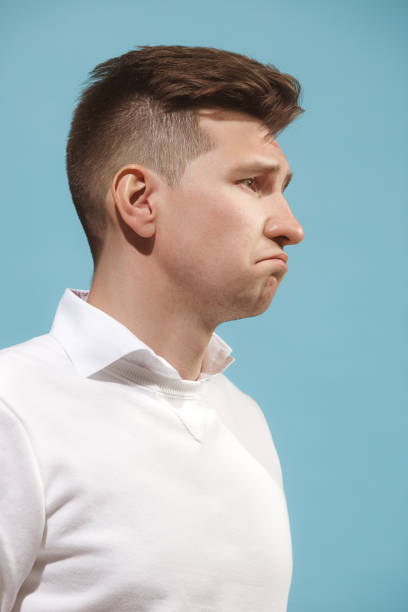istock Beautiful bored man isolated on studio background 959826462