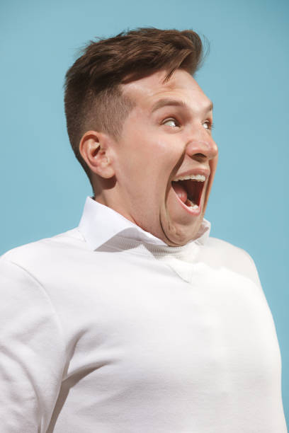 istock The happy business man standing and smiling against studio background 959827142