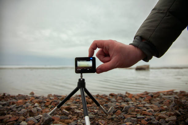 istock Male hand includes action camera, shoot marine look 959837192