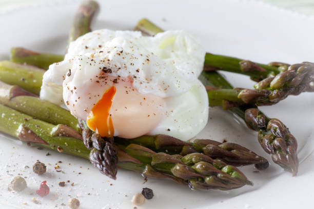 istock Poached Egg on Asparagus with Pepper corn Seasoning 959841590