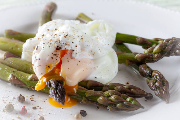 istock Poached Egg on Asparagus with Pepper corn Seasoning 959841600