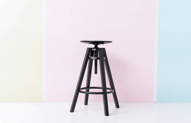 istock Closeup black chair put on colorful pastel background. 959842108
