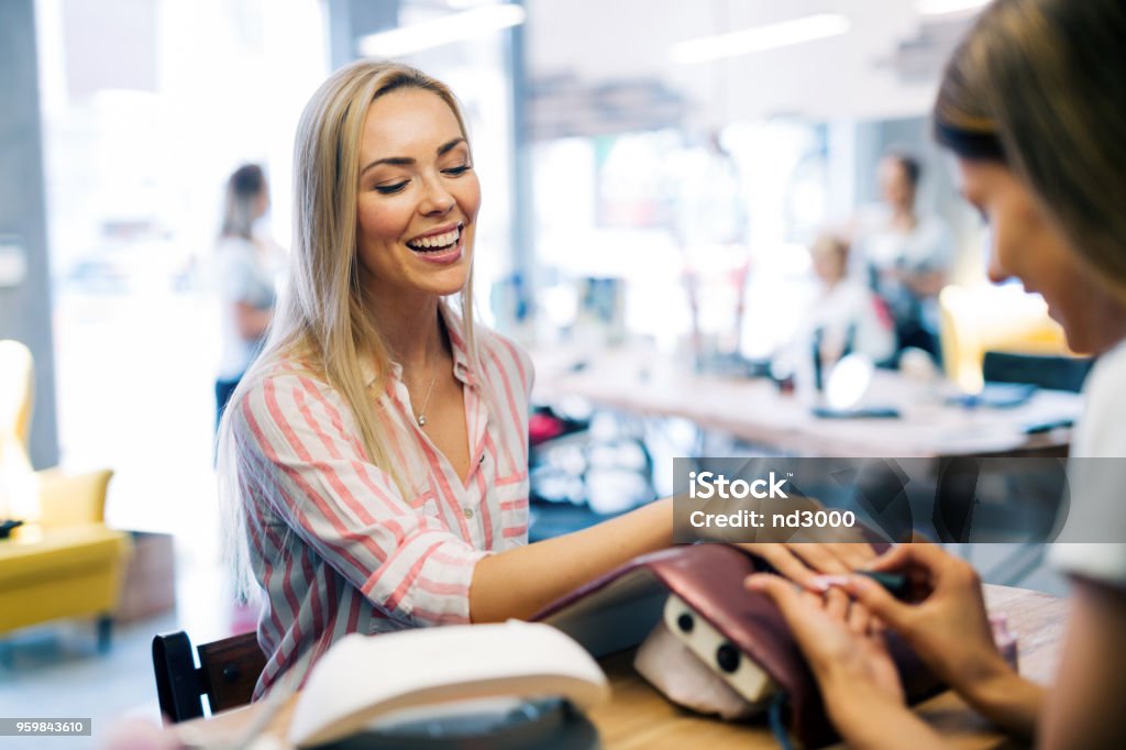 Happy girl getting her nails done at the salon Happy girl getting her nails done at the beauty salon Manicure Stock Photo