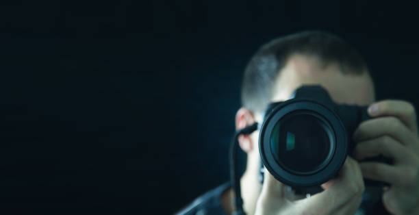 istock Professional photographer holding a DSLR camera. 959844242