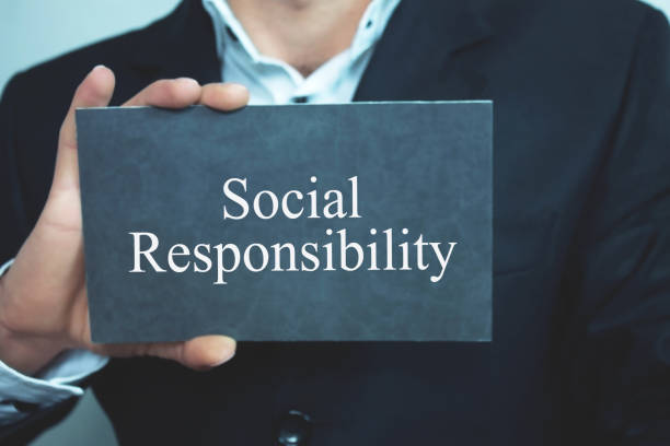 istock Businessman showing Social Responsibility word on cardboard. 959844264