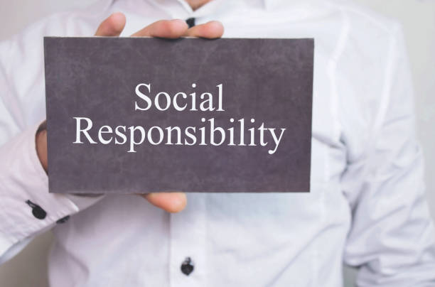 istock Businessman showing Social Responsibility word on cardboard. 959844280