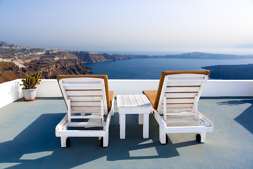 Relaxing benches to watch sunset in Santorini Island, Greece. View toward Caldera sea.