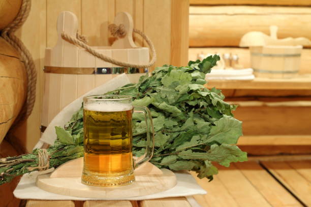 a mug of beer in the sauna. - wooden hub imagens e fotografias de stock