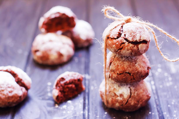 Chocolate crackle cookies on dark wooden background