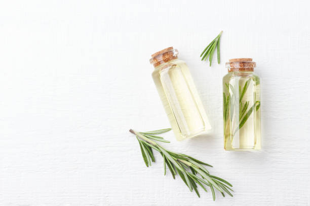istock Extracts of herbs rosemary on white background 959859602