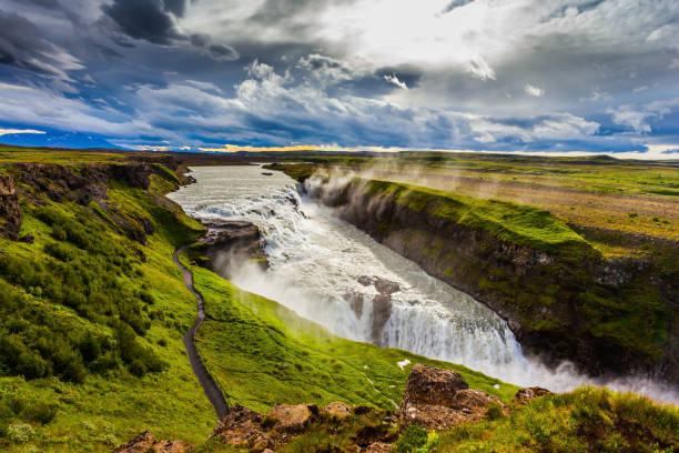 on the shore of the waterfall is a path - gullfoss falls imagens e fotografias de stock