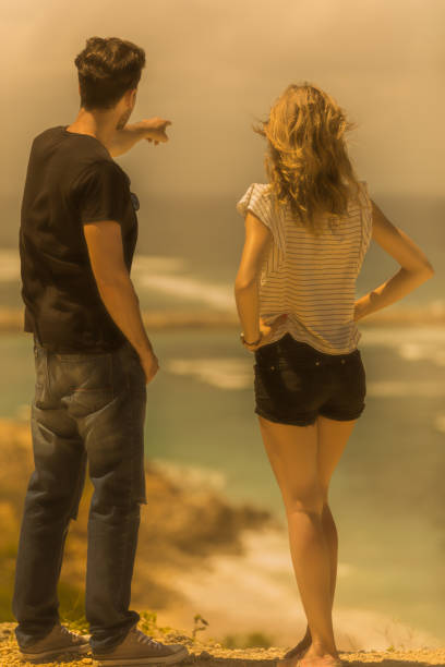 Couple looking at a tropical ocean / sea scenery.