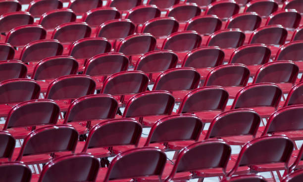istock Red chairs for event in stadium or building 959865664
