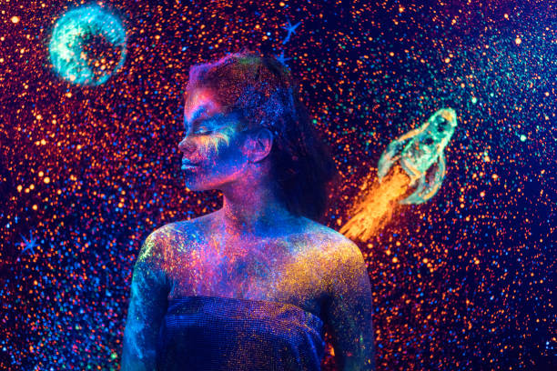 young space woman with fluorescent makeup on starry sky backdrop - spacewoman imagens e fotografias de stock