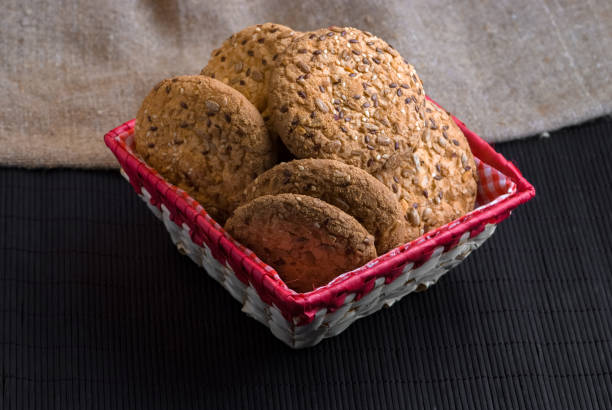 istock Savory cookies sprinkled with sesame seeds, sunflower on table and burlap background 959868674