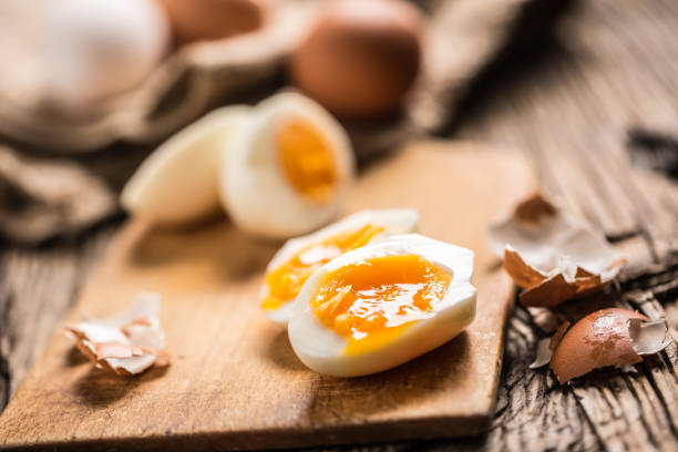 istock Close-up boiled or raw chicken eggs on wooden board 959868786