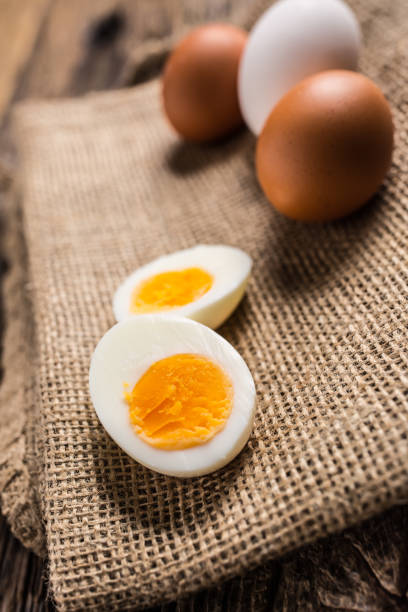 istock Close-up boiled or raw chicken eggs on wooden board 959868792