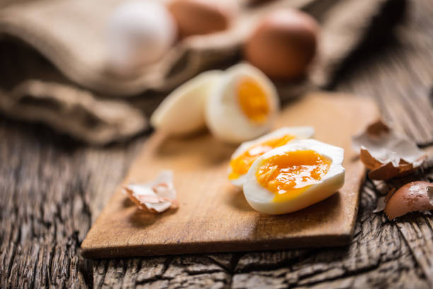 istock Close-up boiled or raw chicken eggs on wooden board 959868816
