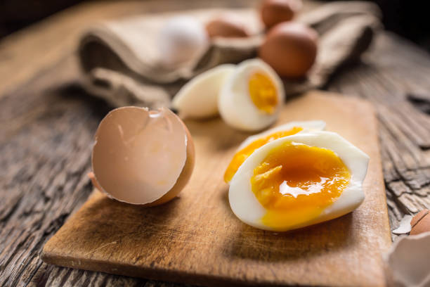 istock Close-up boiled or raw chicken eggs on wooden board 959868860