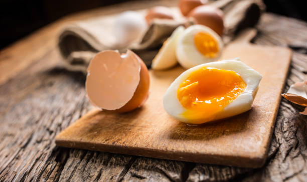 istock Close-up boiled or raw chicken eggs on wooden board 959868862