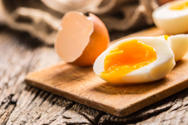 istock Close-up boiled or raw chicken eggs on wooden board 959868874