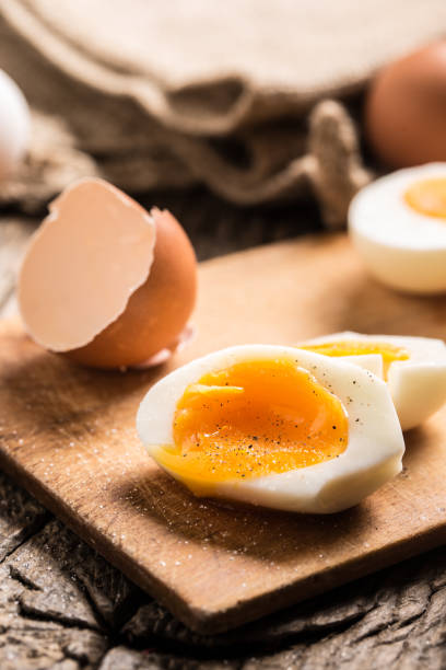 istock Close-up boiled or raw chicken eggs on wooden board 959868910