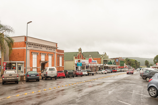 GREYTOWN, SOUTH AFRICA - MARCH 22, 2018: A street scene on a rainy day with businesses, vehicles and people in Greytown in the Kwazulu-Natal Province