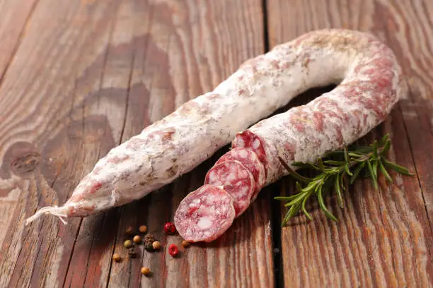 Photo of salami on wood background