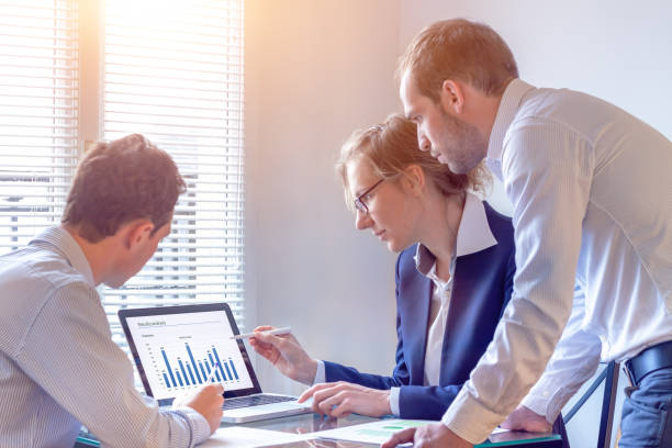 istock Accounting team discussing financial report data, office, consultant business strategy 959875706