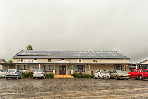 HOWICK, SOUTH AFRICA - MARCH 22, 2018: Businesses and vehicles at the Piggly Wiggly shopping centre, near Howick, in the Kwazulu-Natal Midlands Meander. Solar panels are visible on the roof