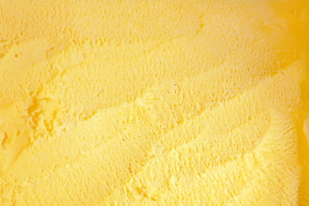close up vanilla ice cream from above show spoon scratching texture stock photo