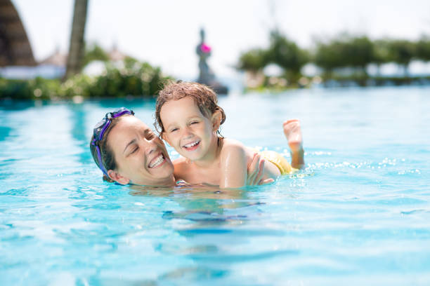 First time in swimming pool Mother teaching her little son swimming hot vietnamese women pictures stock pictures, royalty-free photos & images
