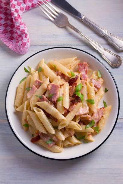 istock Penne pasta with bacon and sundried tomatoes 959880220
