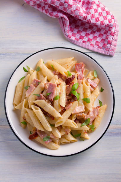 istock Penne pasta with bacon and sundried tomatoes 959880780