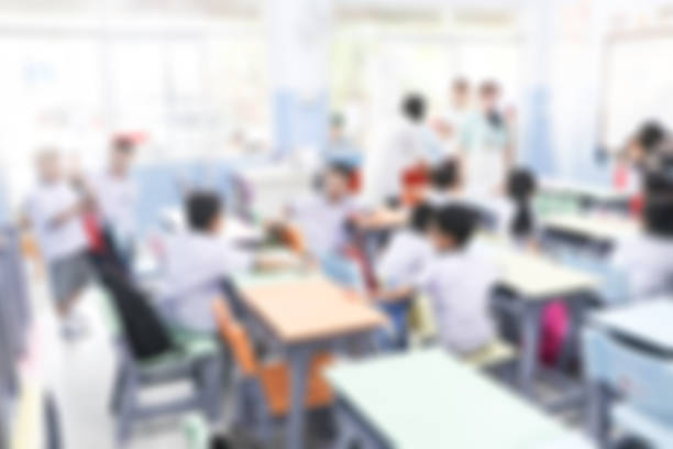 Blurred primary school with parent and children in background.Defocus open house day at for kindergarten students. stock photo