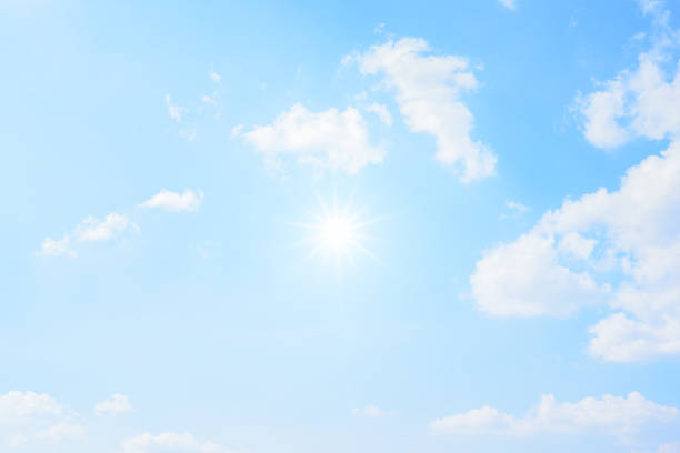 istock Sun with sunlight in white clouds on blue sky. 959883824