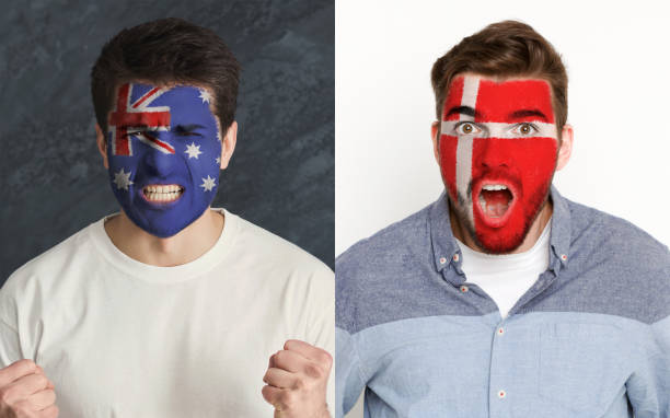 istock Emotional soccer fans with painted flags on faces 959897724