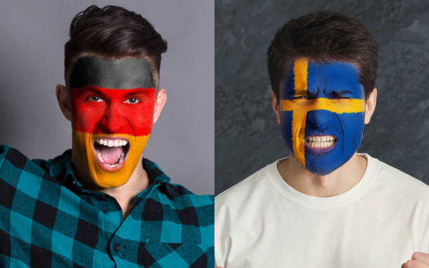 istock Emotional soccer fans with painted flags on faces 959897768