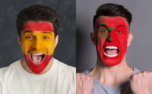 istock Emotional soccer fans with painted flags on faces 959897822