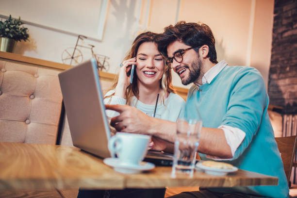 istock Young couple working on laptop in cafe 959900662
